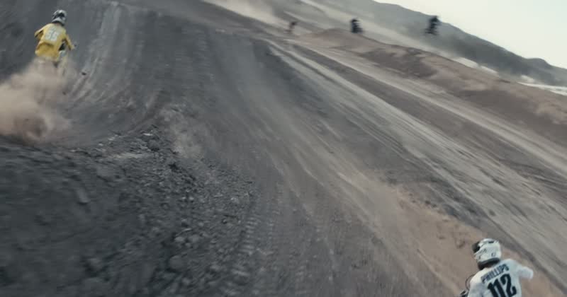 Aerial view of two riders through a rutted corner, the frame a live downlink would carry.