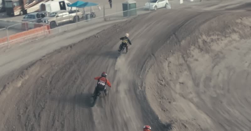 Chase-cam frame behind a pack of riders, the kind of shot cut into a vertical reel.